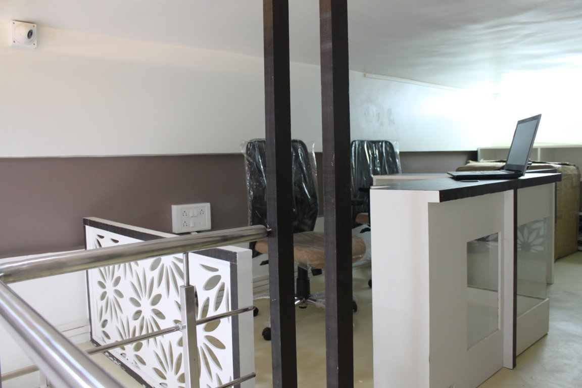 Mezzanine administrative workspace at Insight Institute with a stainless steel stair rail, laser-cut floral balustrade and standing desks for staff